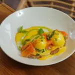 Close-up of Eggs Benedict with smoked salmon and hollandaise sauce.
